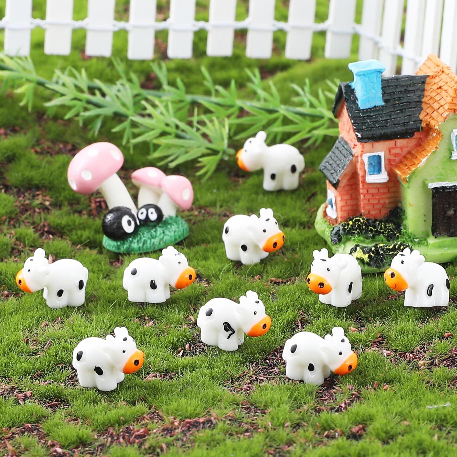 DWWPOO mini cows garden terrarium decor adds whimsy to moss landscapes.