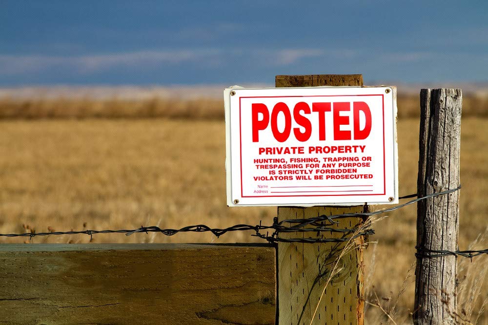 Dxyizus Signs easy-install no trespassing sign with four pre-drilled holes.