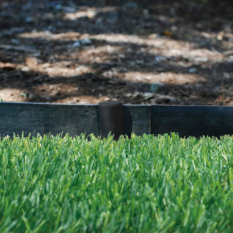 EasyFlex edging curves smoothly around plants for defined garden shapes.