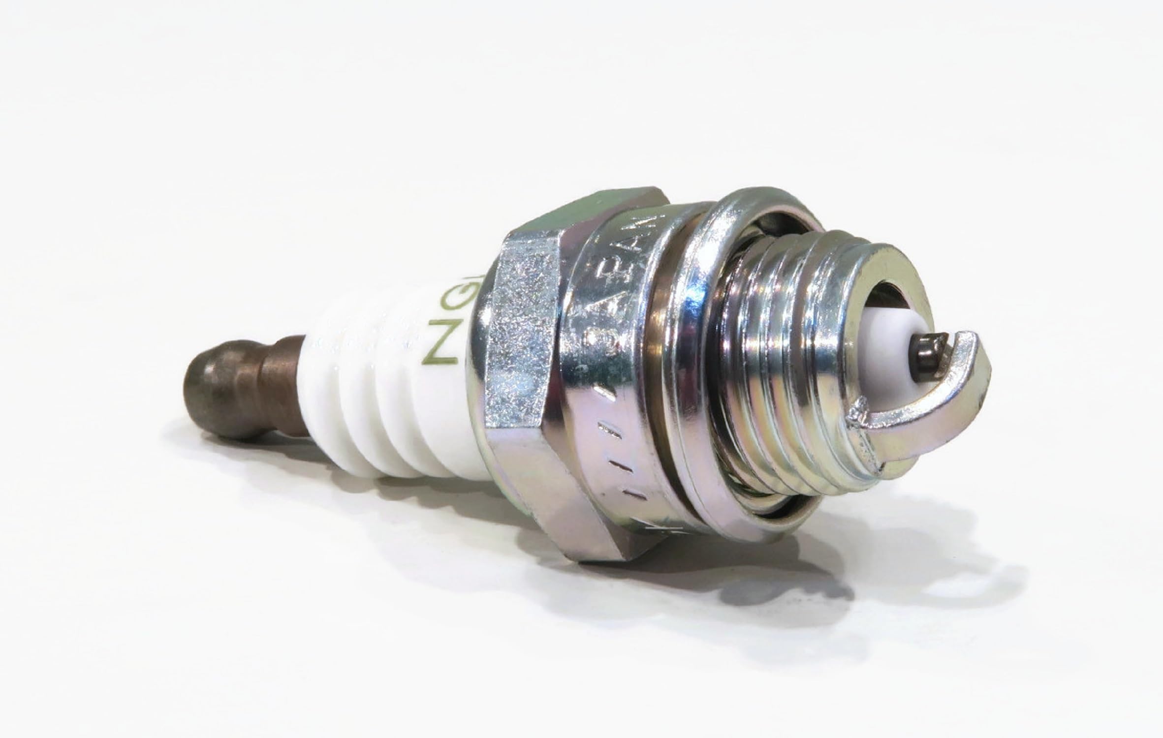 Durable spark plug construction designed for outdoor machinery and routine use.