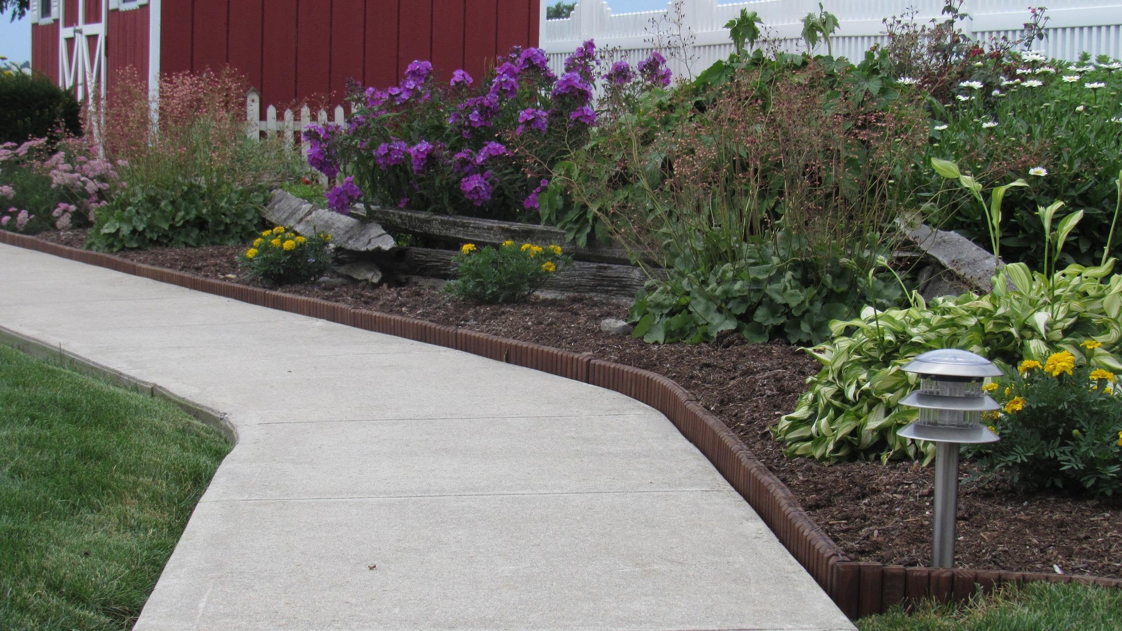 Eco-Green edging with pre-attached stakes enables fast no-dig installation.