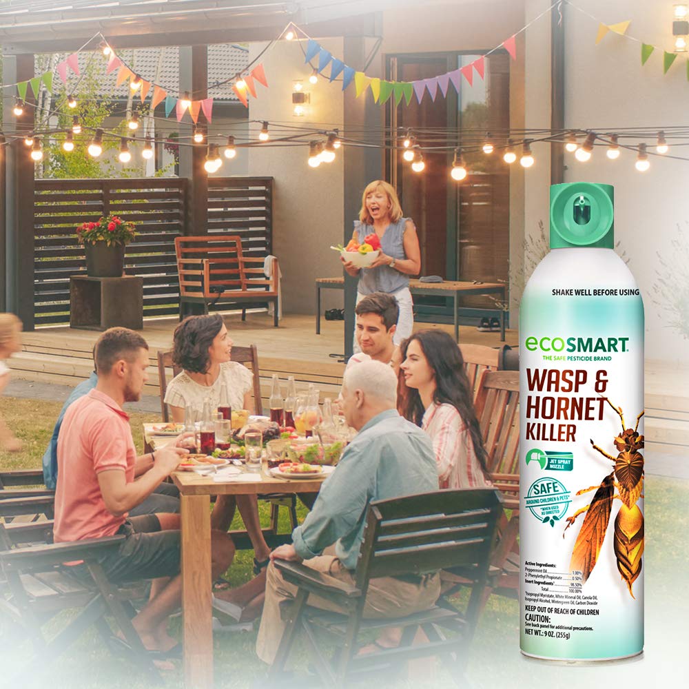 EcoSmart plant-based formula spray beside fresh herbs, offering chemical-free protection.