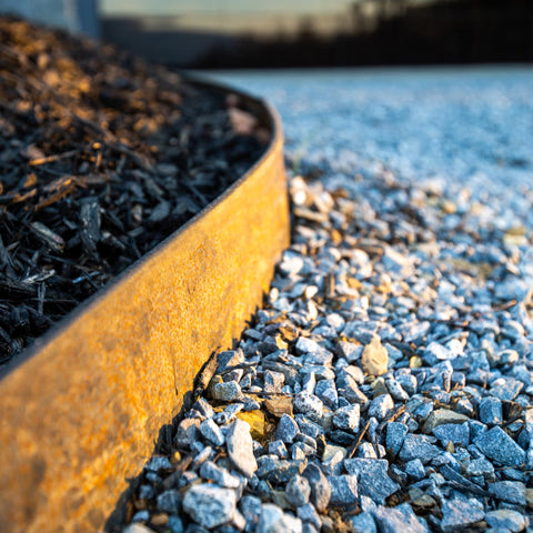 Edge Right rust patina forming on steel edging for a modern landscape look.