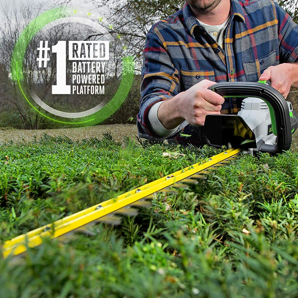 HT2411 battery and charger powering cordless hedge work on the go.