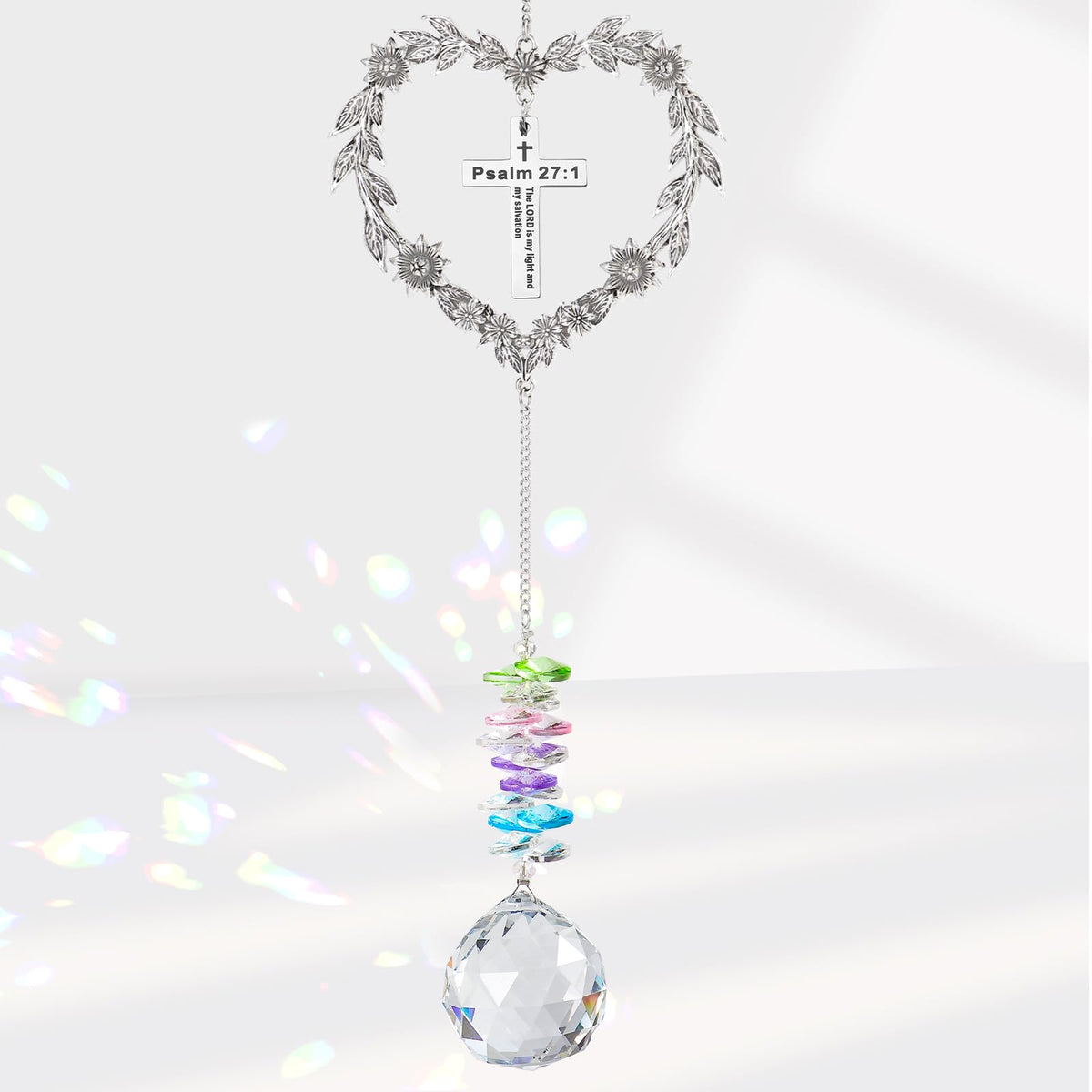 Elivida heart-shaped suncatcher with cross catching sunlight to inspire faith.