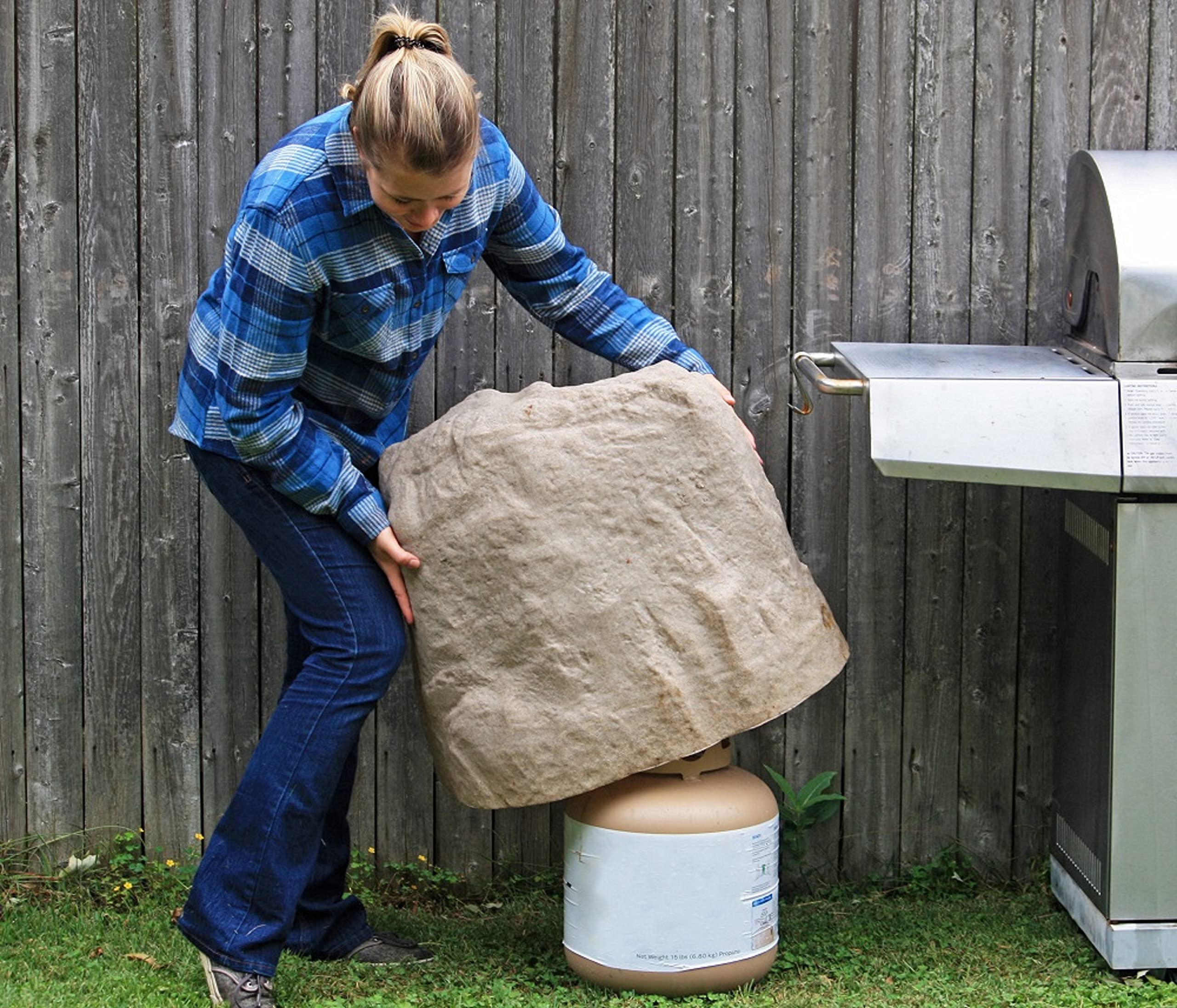 Emsco Group 2181 Large rock with two stakes for secure anchoring.