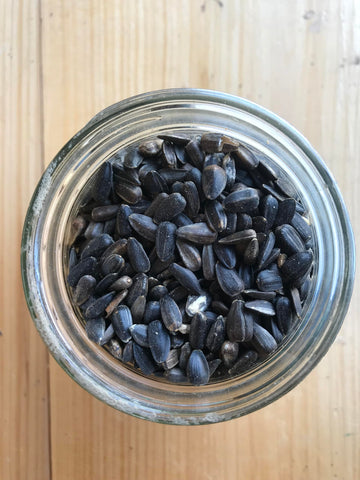 Ernst Grain & Livestock outdoor bird feeder setup with black oil sunflower seeds.