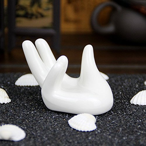 Close-up of Eshylala white ceramic hand air plant holder surface.