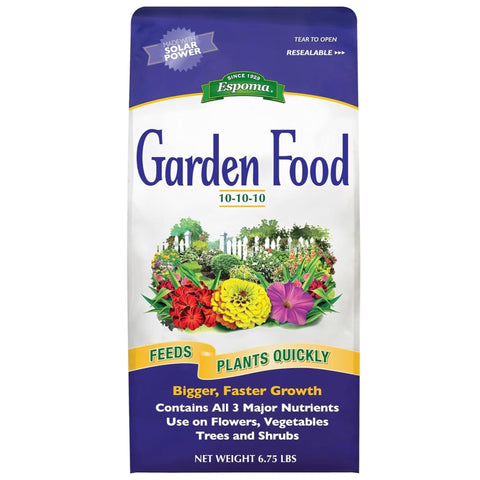 Espoma Garden Food being applied to soil around a shrub.
