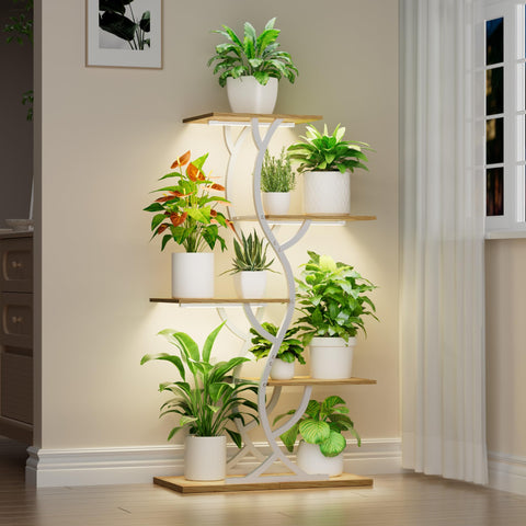 EVAWOO plant stand with grow lights set up in a corner.