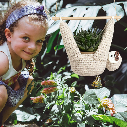 Evbopa sloth planter hangs succulent pots in a cozy corner.
