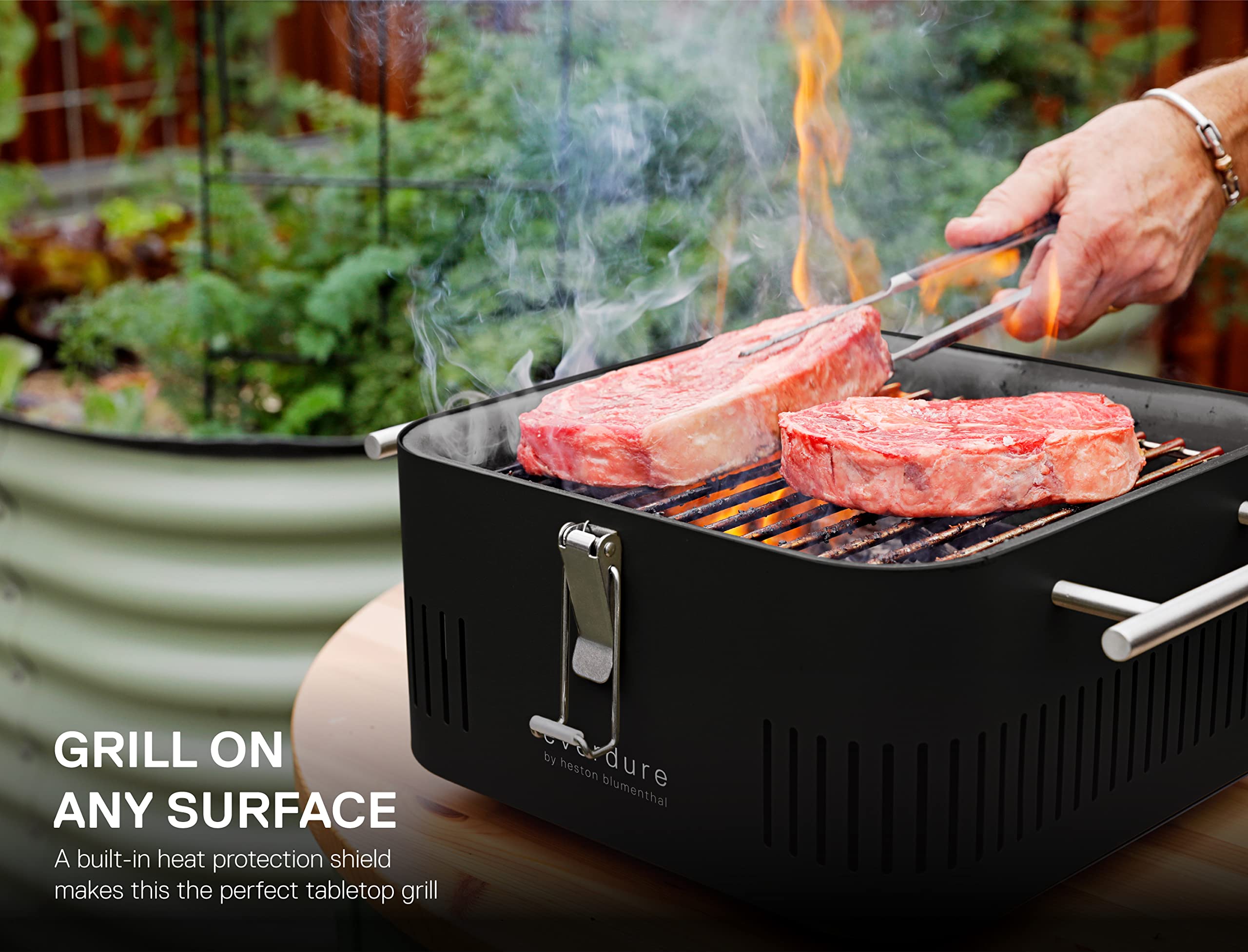 Everdure CUBE chrome handles stay cool to touch during grilling.