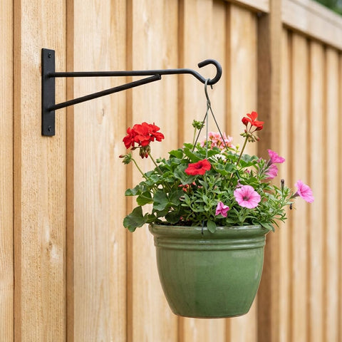 Eyrosa lantern hanger bracket adds warm light to a porch.