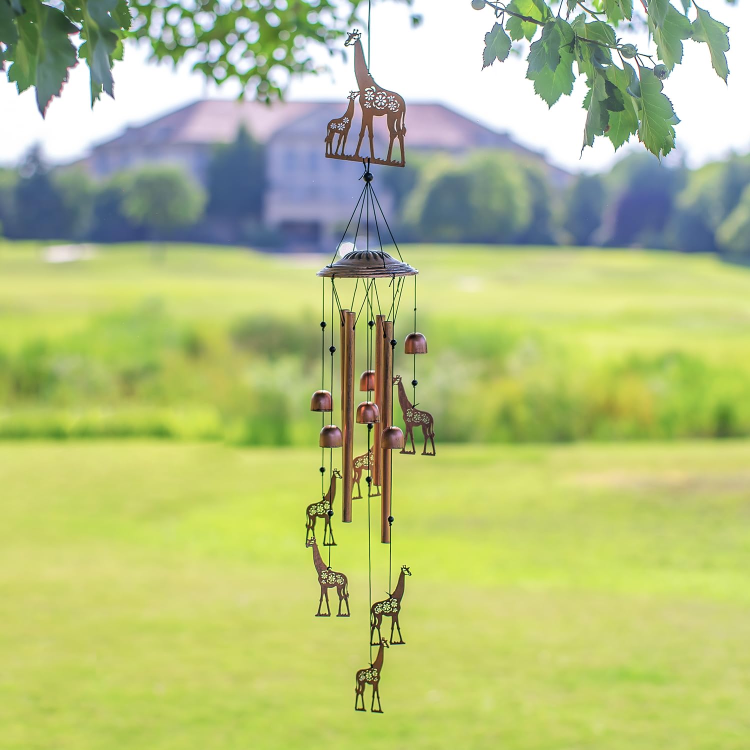 EZTZEN giraffe wind chime in yard scene, inviting family gatherings.