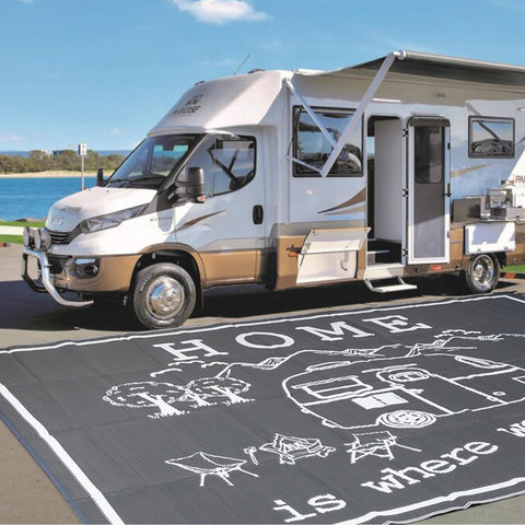 FACOYANS RV outdoor rug 9x12 laid beside an RV for spacious outdoor comfort.