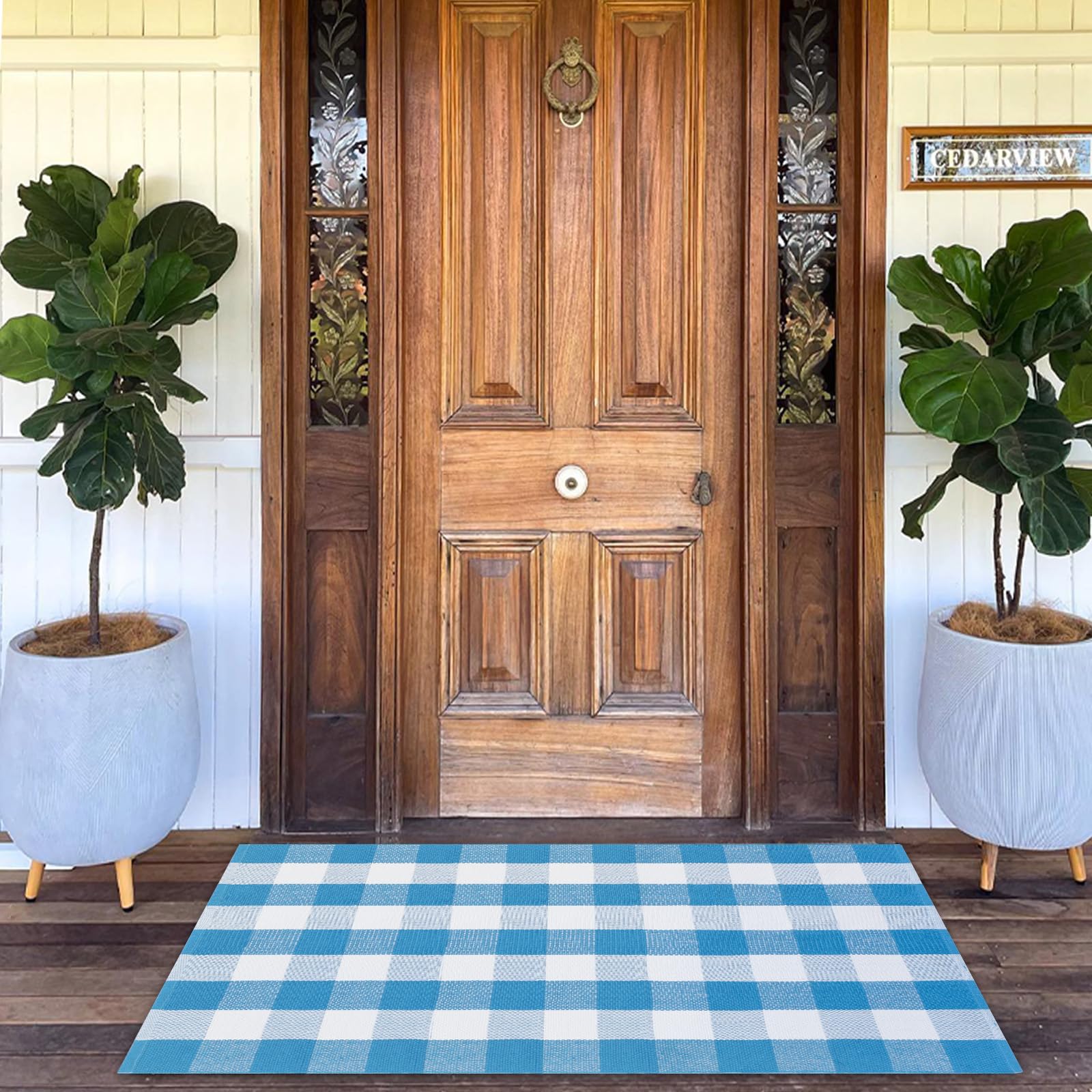 Fallovea blue and white plaid rug on the front porch, durable for high-traffic entryways.