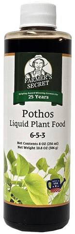 Farmer's Secret Pothos liquid food bottle label emphasizes nutrient-rich formula for strong roots
