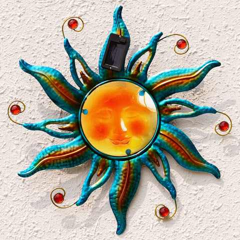 Fashionoda solar sun face wall art in blue with LED glow for outdoor ambiance.