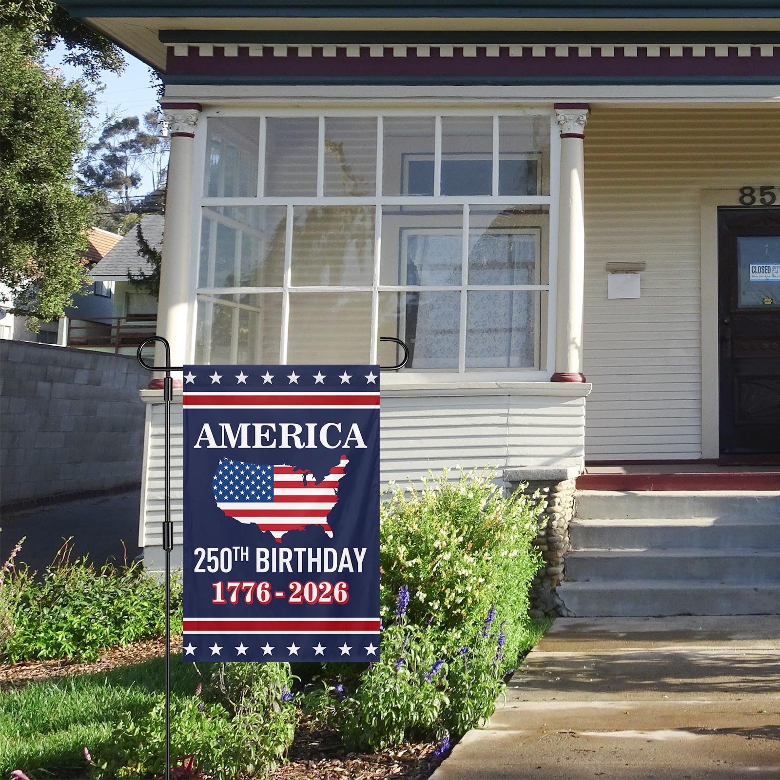 Feeniss garden flag displayed on a porch rail during celebration