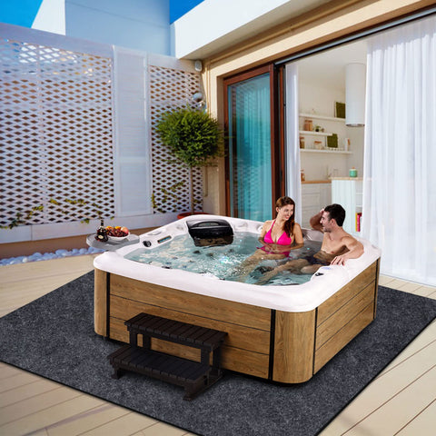 FENXAM mat used outdoors under a hot tub, pool, or barbecue setup for spill protection.