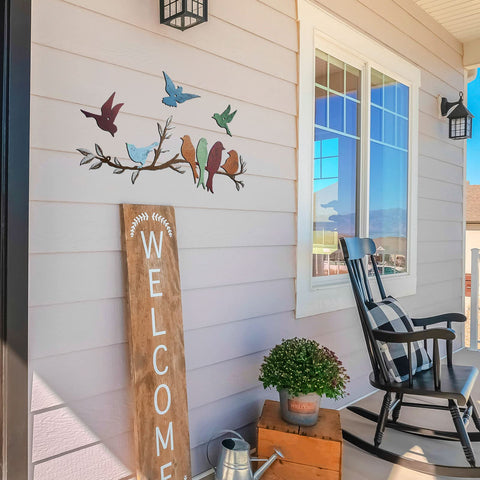 Ferraycle metal wall art with perched birds enhances living and dining areas.