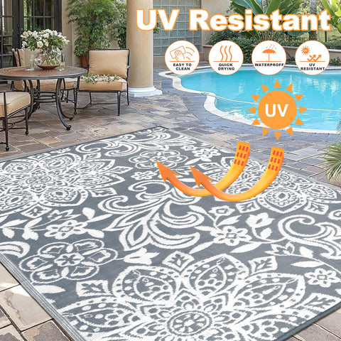 Findosom outdoor rug shows corner loops and stakes for secure placement.