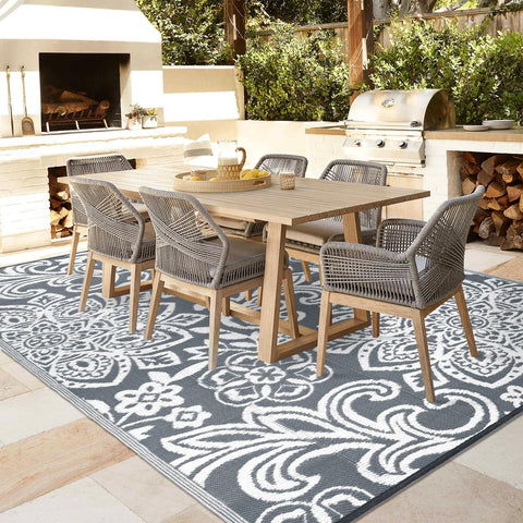Findosom versatile outdoor rug placed on patio and beach scenes