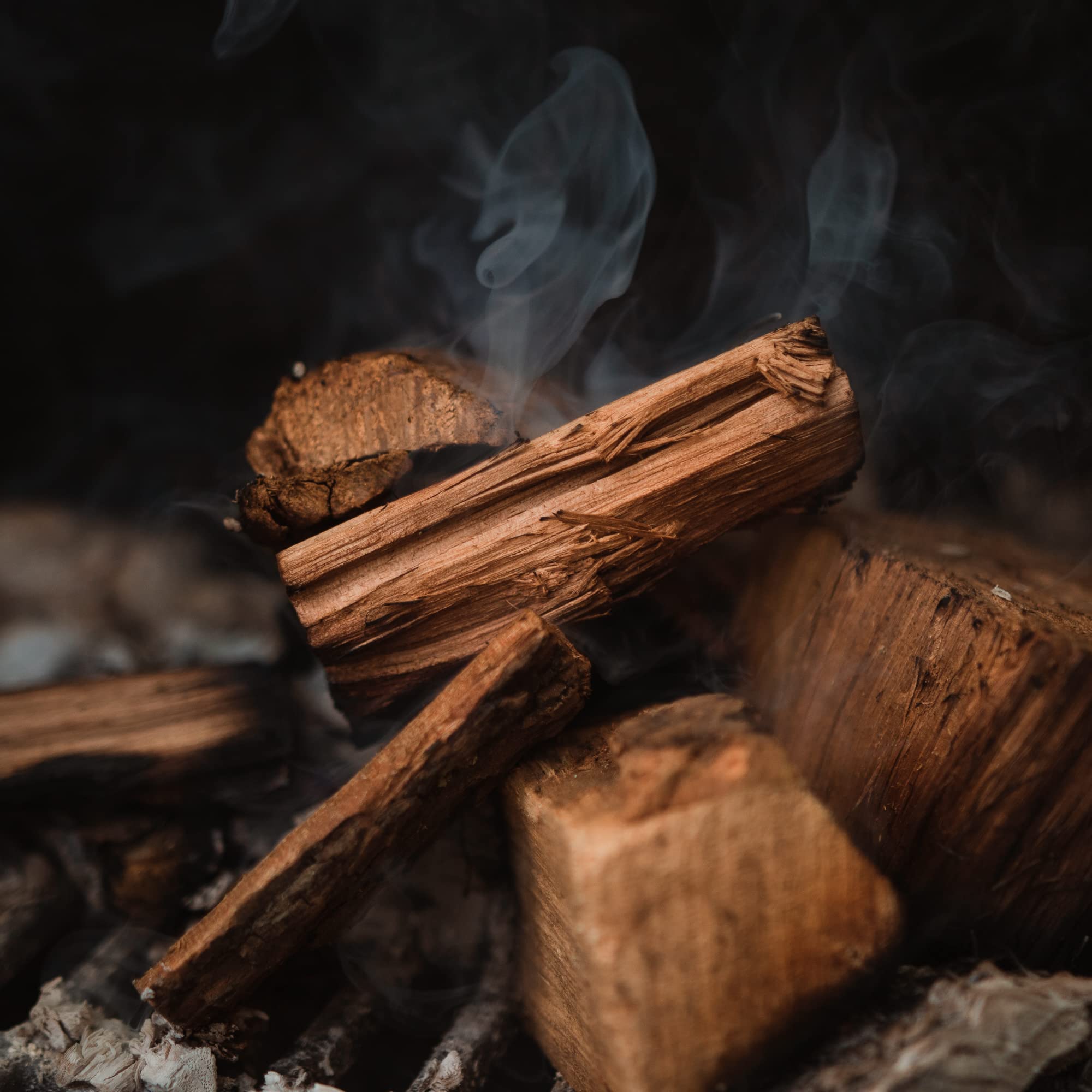 Fire & Flavor hickory chunks pouring into foil pan for easy use