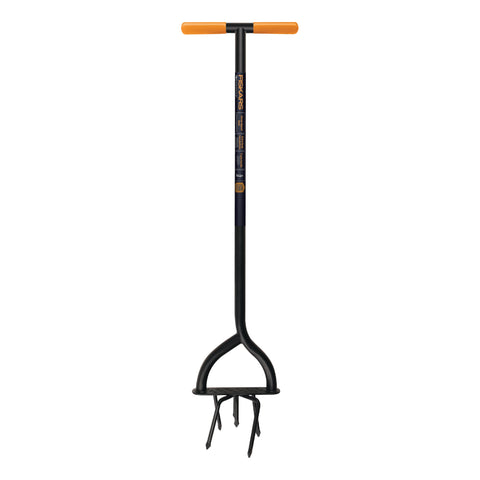 Fiskars 40in steel tiller in action reduces kneeling and loosens tough soil.