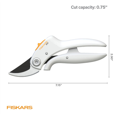 Bright white Fiskars pruner stands out in the garden for quick access.