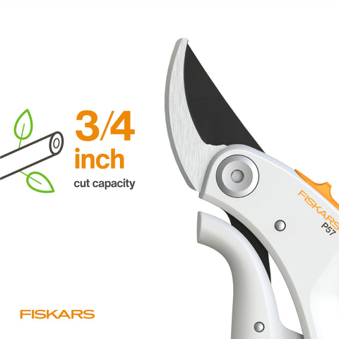 Fiskars pruner in garden setting demonstrates ergonomic design during pruning.
