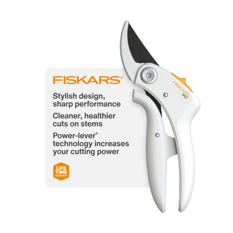 Fiskars Bypass Pruner PowerLever in hand delivering clean, precise cuts on a branch.