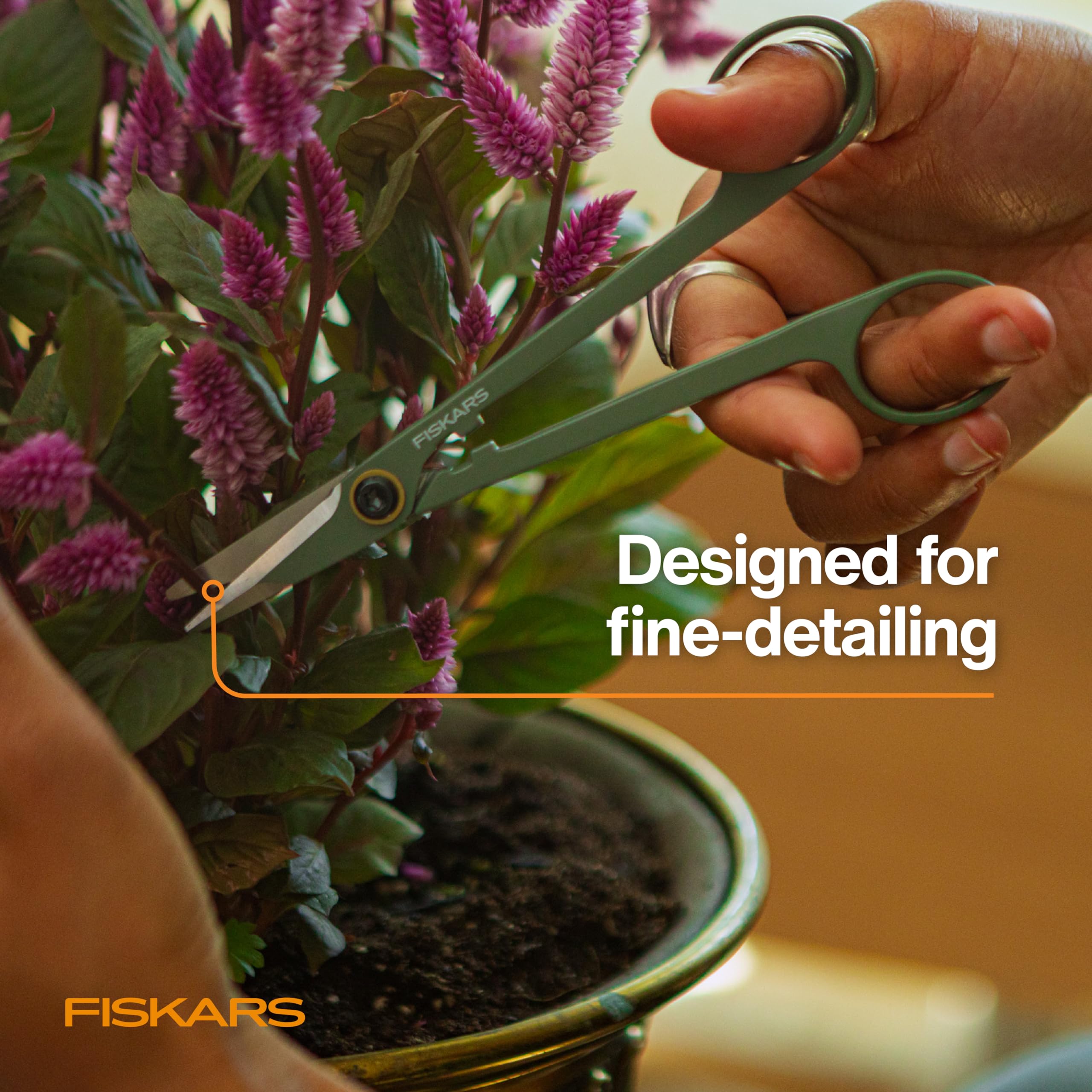 Fiskars Snipper with free-standing caddy stored beside indoor garden.