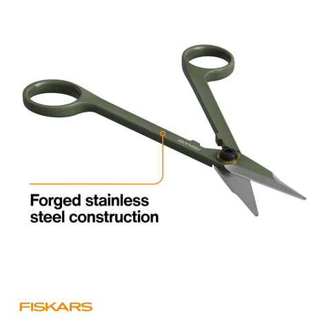 Precise detailing with Fiskars Snipper shaping small-leaf plants.