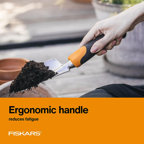 Fiskars Ergo Trowel used for digging in tough soil conditions.