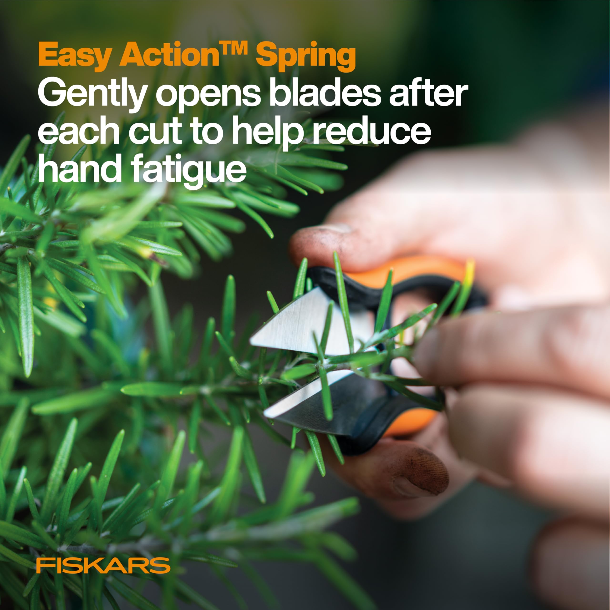 Fiskars herb snips in use cutting fresh herbs from a windowsill garden