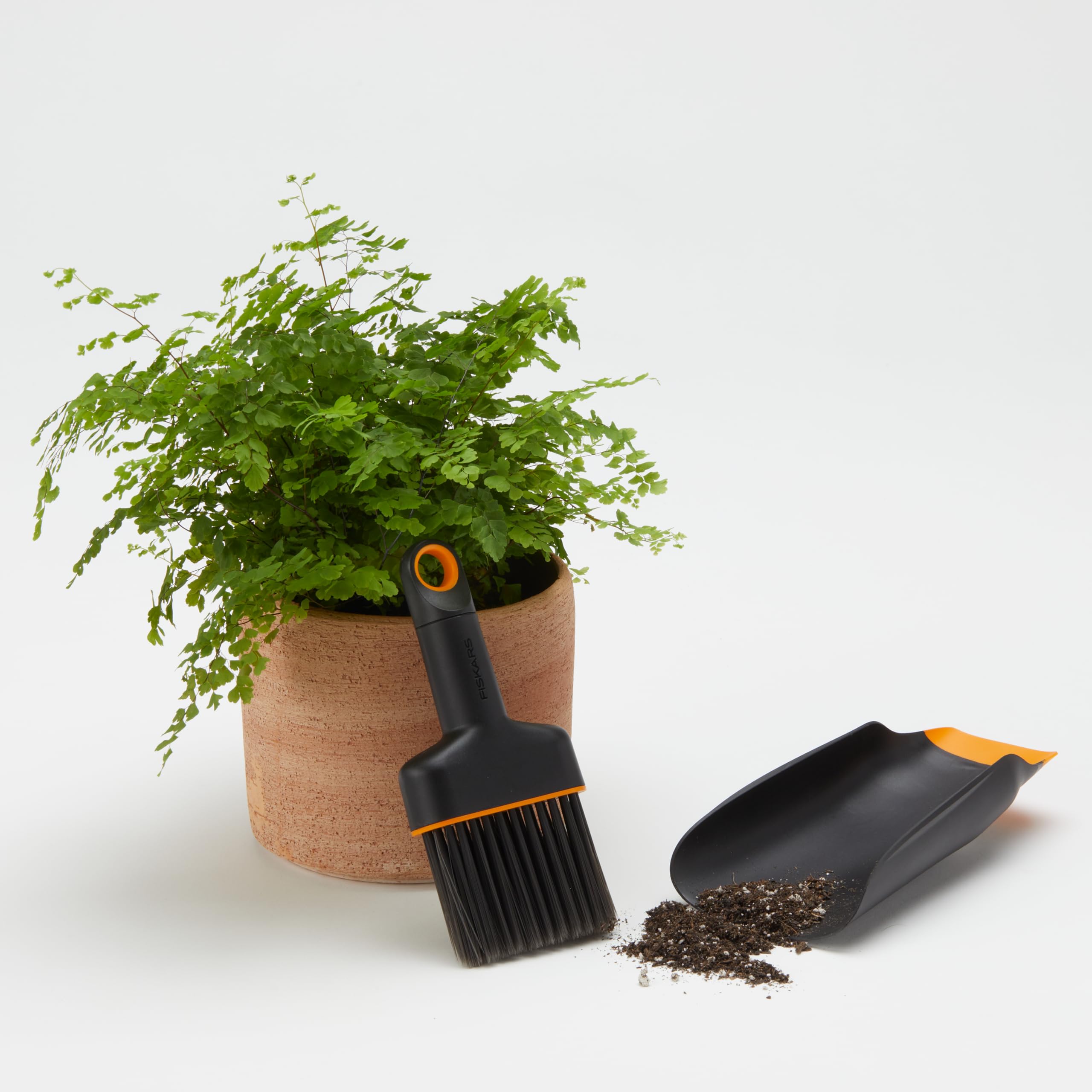 Fiskars Planting Soil Scoop & Brush Set keeps surfaces clean during cleanup