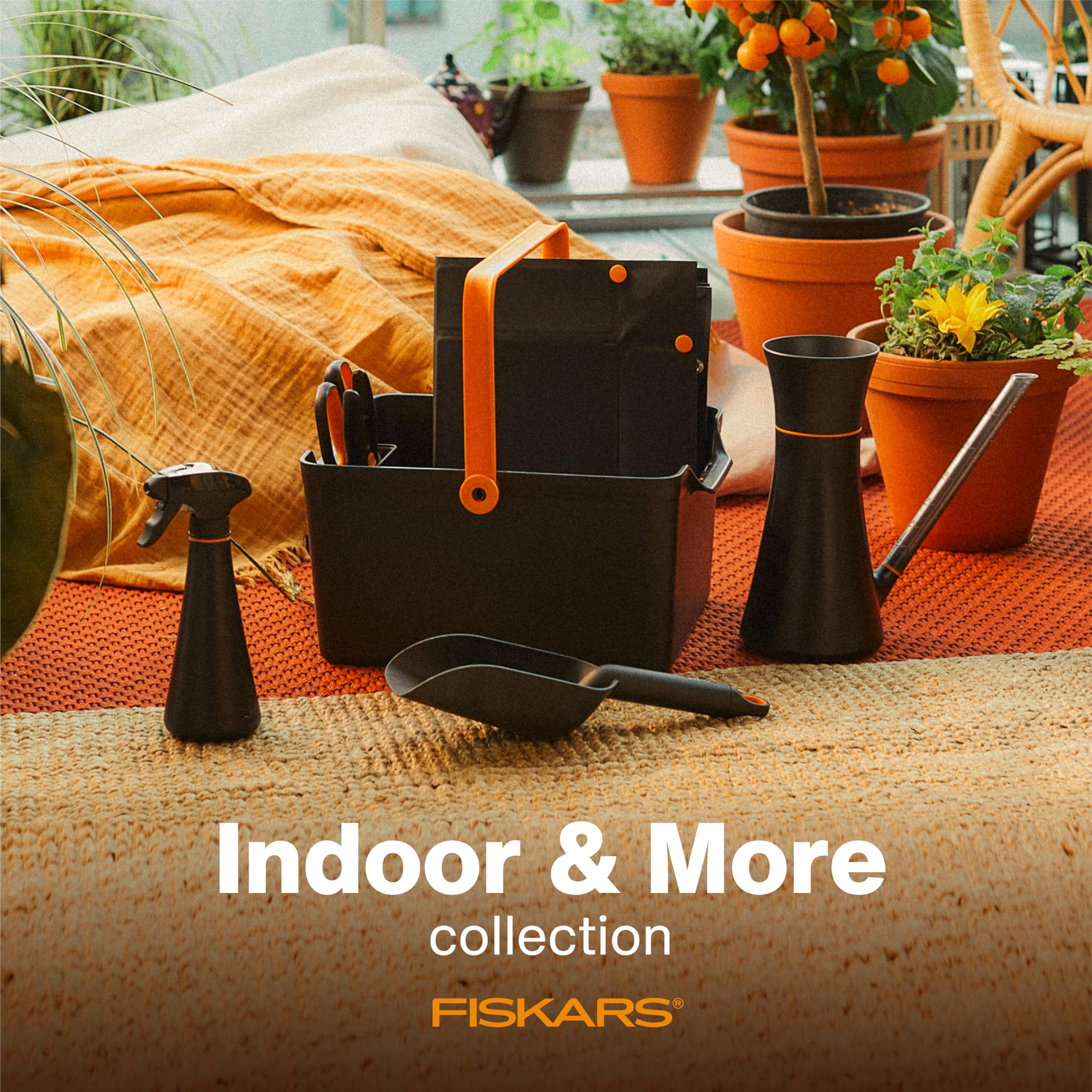 Fiskars soil scoop transferring soil into medium planters during potting.