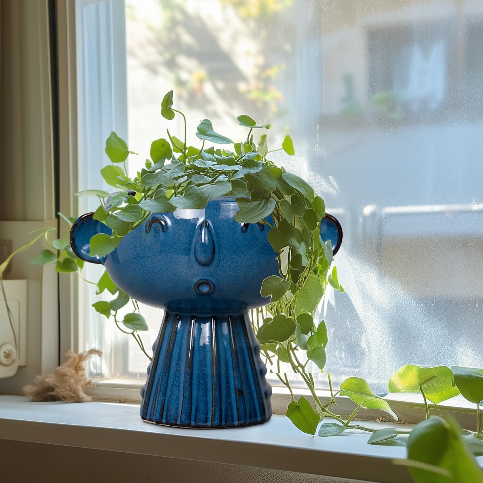 Fivepot head planter on shelf adds whimsical plant display appeal.