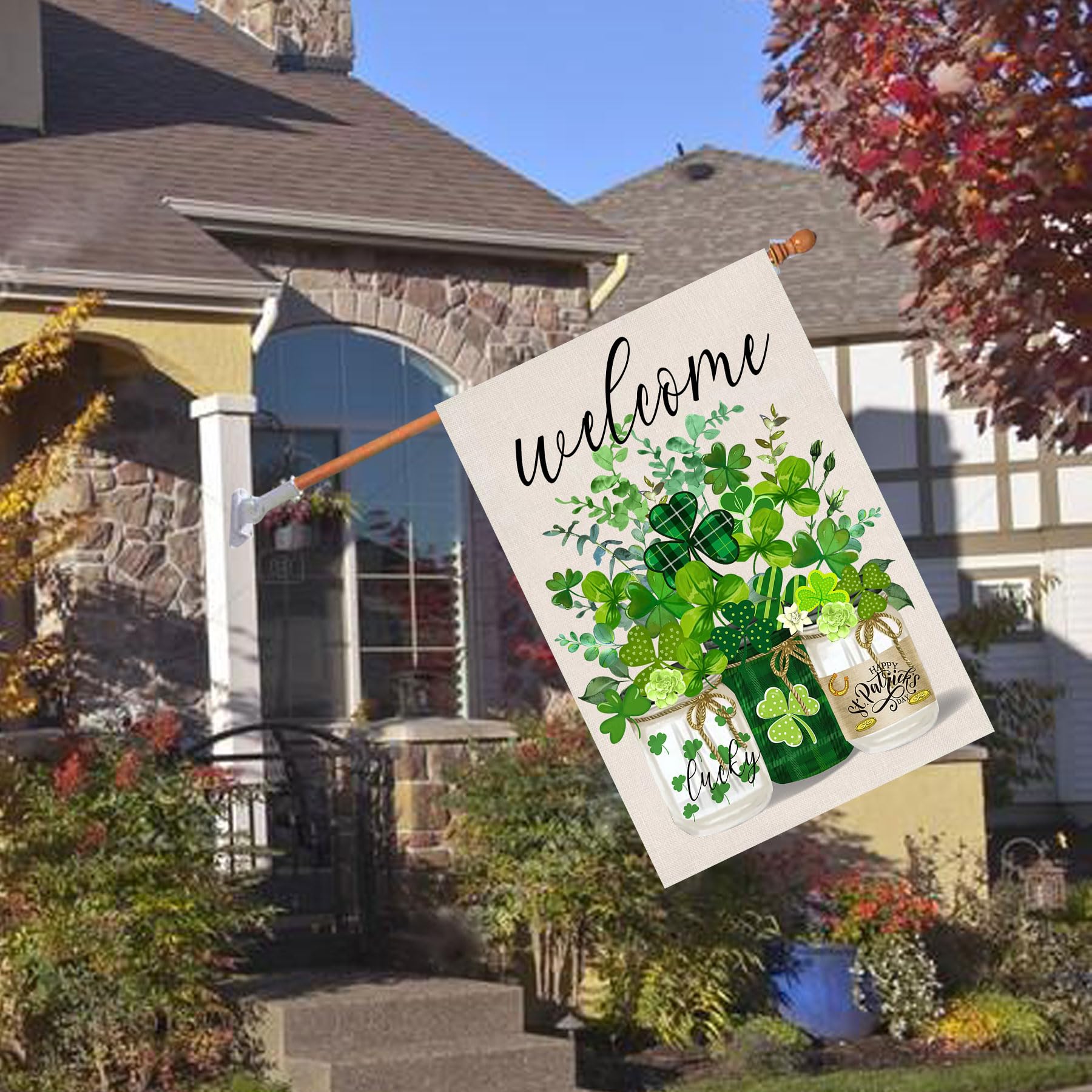 Flagmax garden flag displayed on patio showcasing festive shamrocks.