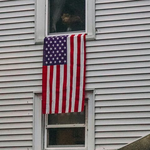 Flagolden outdoor flag on a pole ready for quick display.