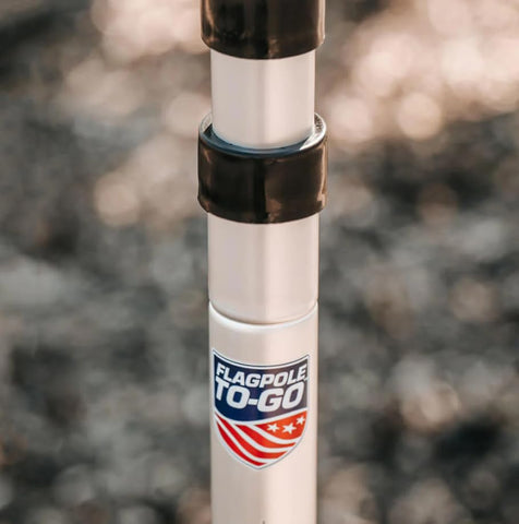 Flagpole-To-Go with two flags clipped for versatility at events.