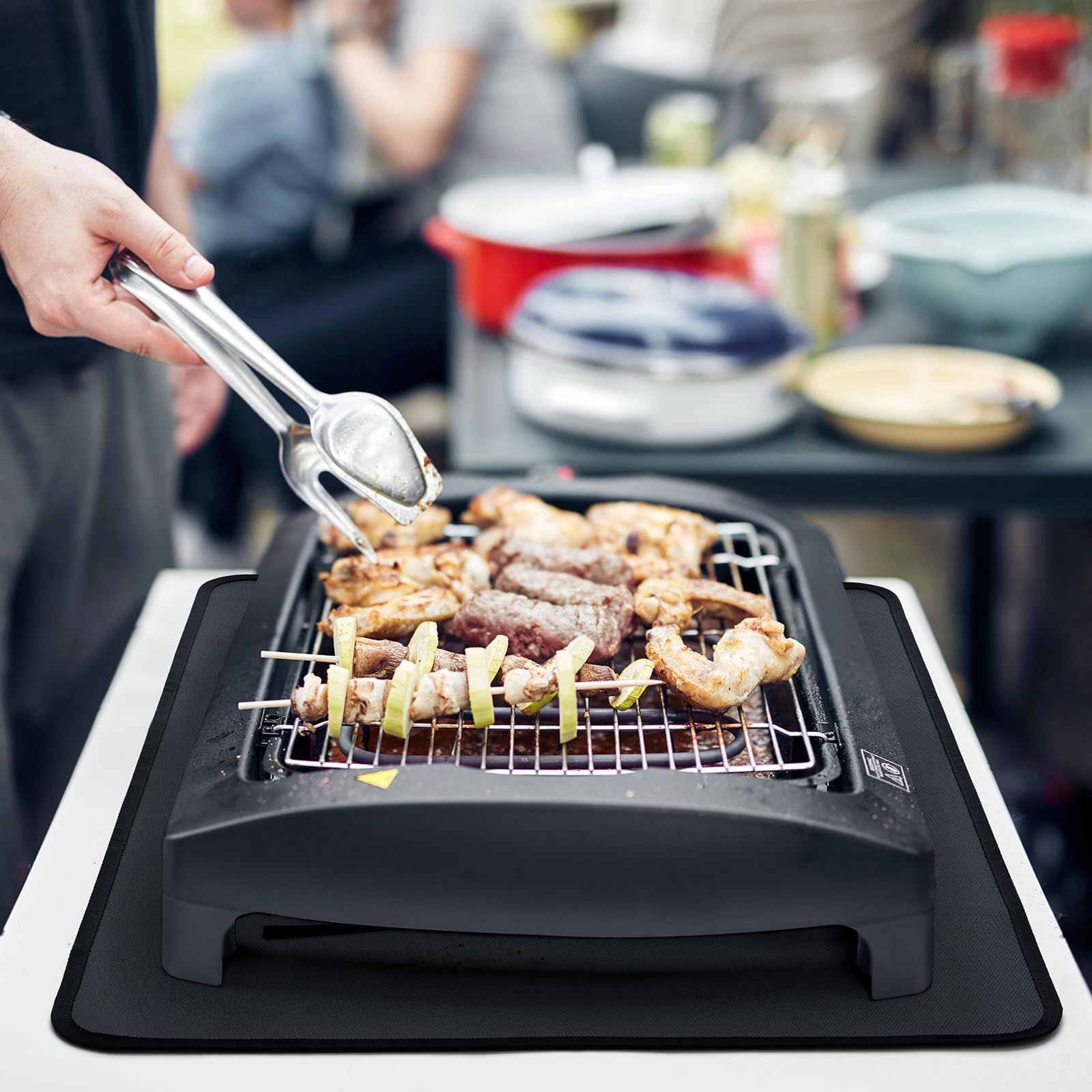 FLASLD 24x36 inch bbq mat laid on a tabletop grill for hygienic, easy-clean prep.