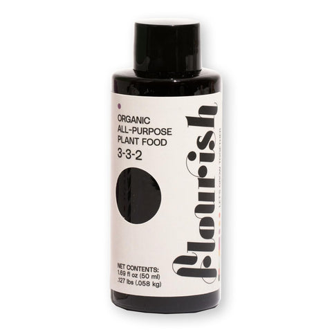Flourish Plant Food bottle pour shows precise dosing for thriving indoor greenery.