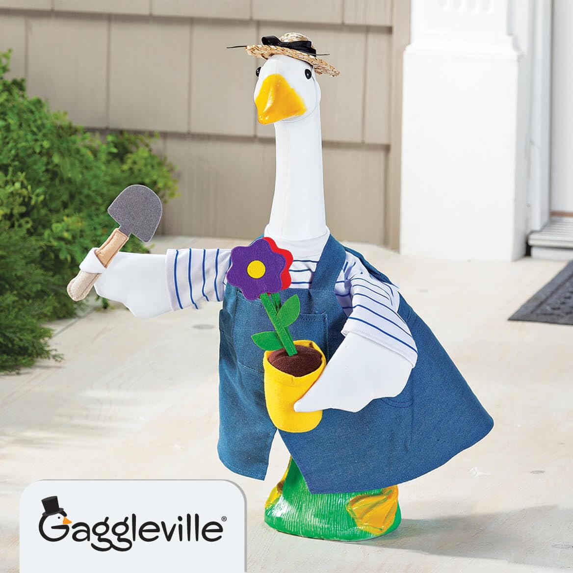 Detail of straw hat and flower pot on goose for authentic gardening whimsy
