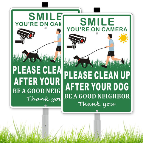 Frohllia sign set in green alerts neighbors to pick up after dogs, keeping yards tidy.