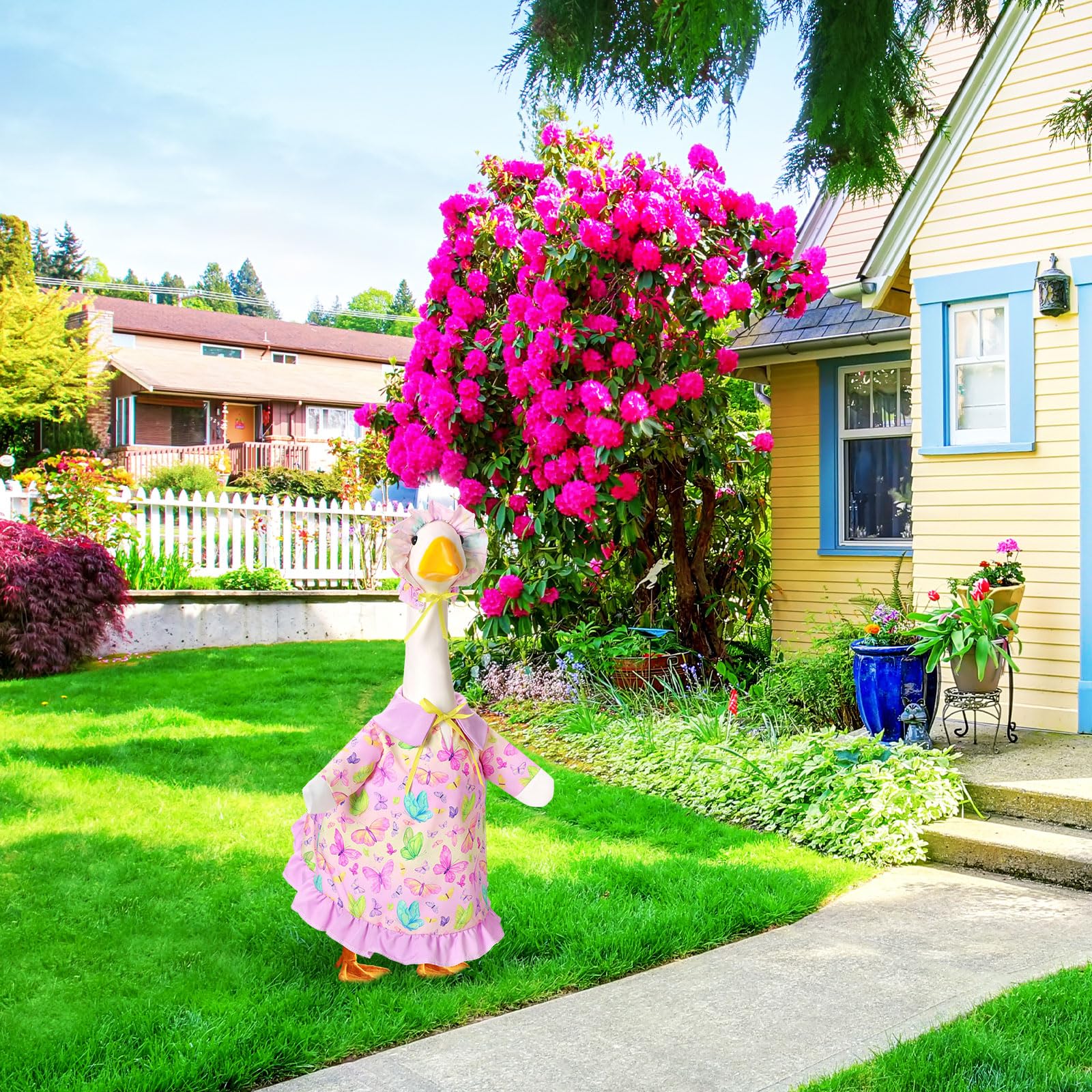 Outdoor display with FuWeave goose outfit enhances garden decor.
