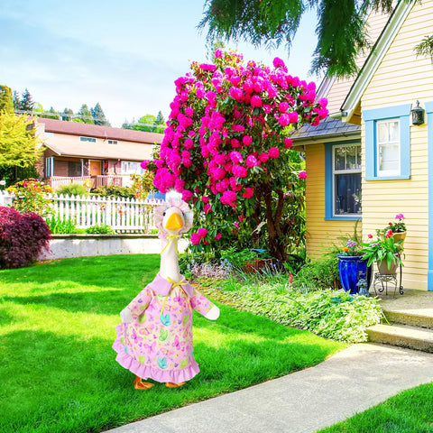 Outdoor display with FuWeave goose outfit enhances garden decor.