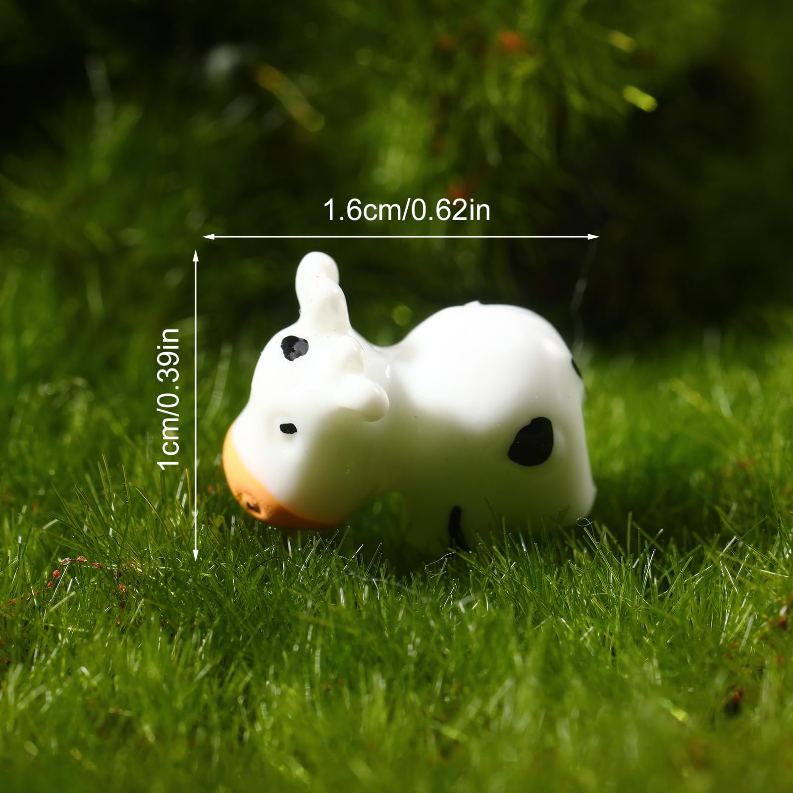 Cute resin cow ornaments for desk or shelf decoration.