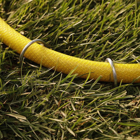 GardenMate landscape fabric anchor works for hoses and cables as well.